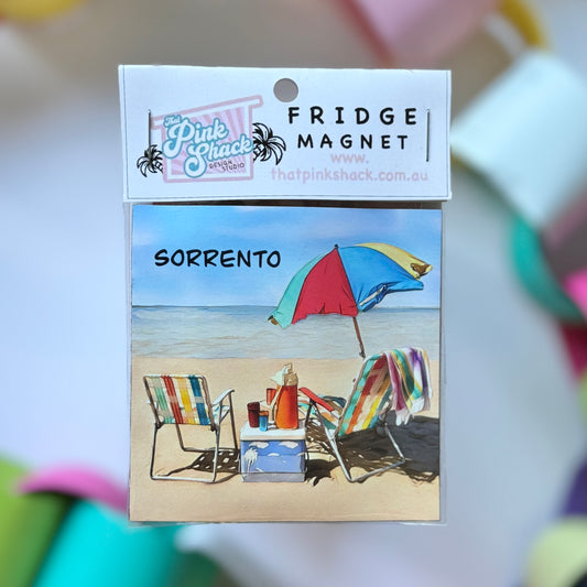 A fridge magnet of sorrento on the mornington peninsula with a vintage beach umbrella and chairs in packaging