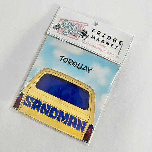 A torquay fridge magnet with a yellow classic Holden sandman panelvan in packaging